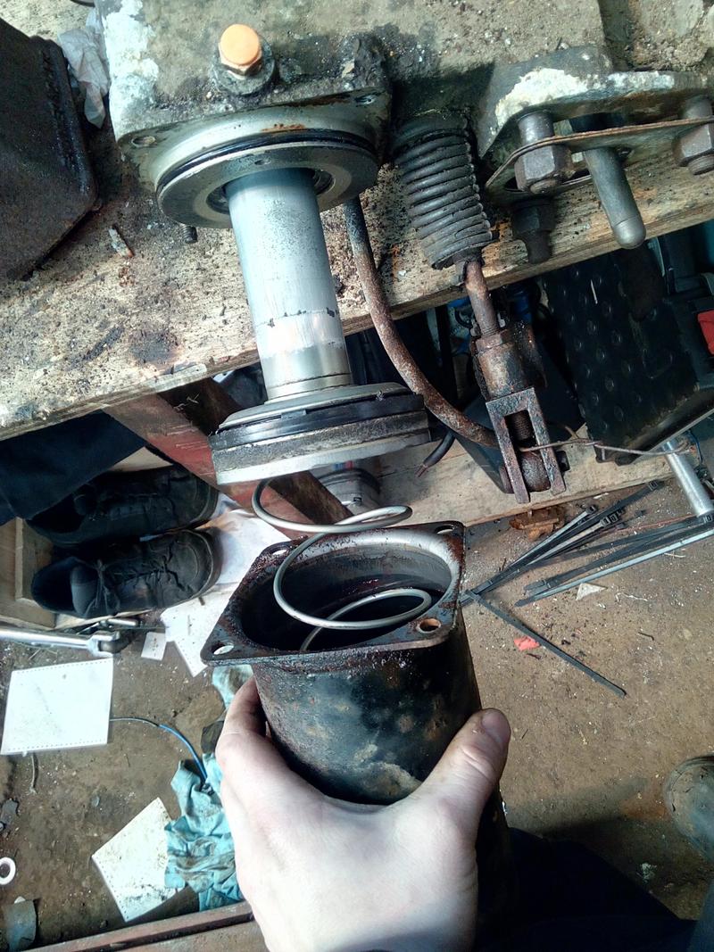 The brake assist servo partially disassembled, revealing a piston
and a very large return-spring.