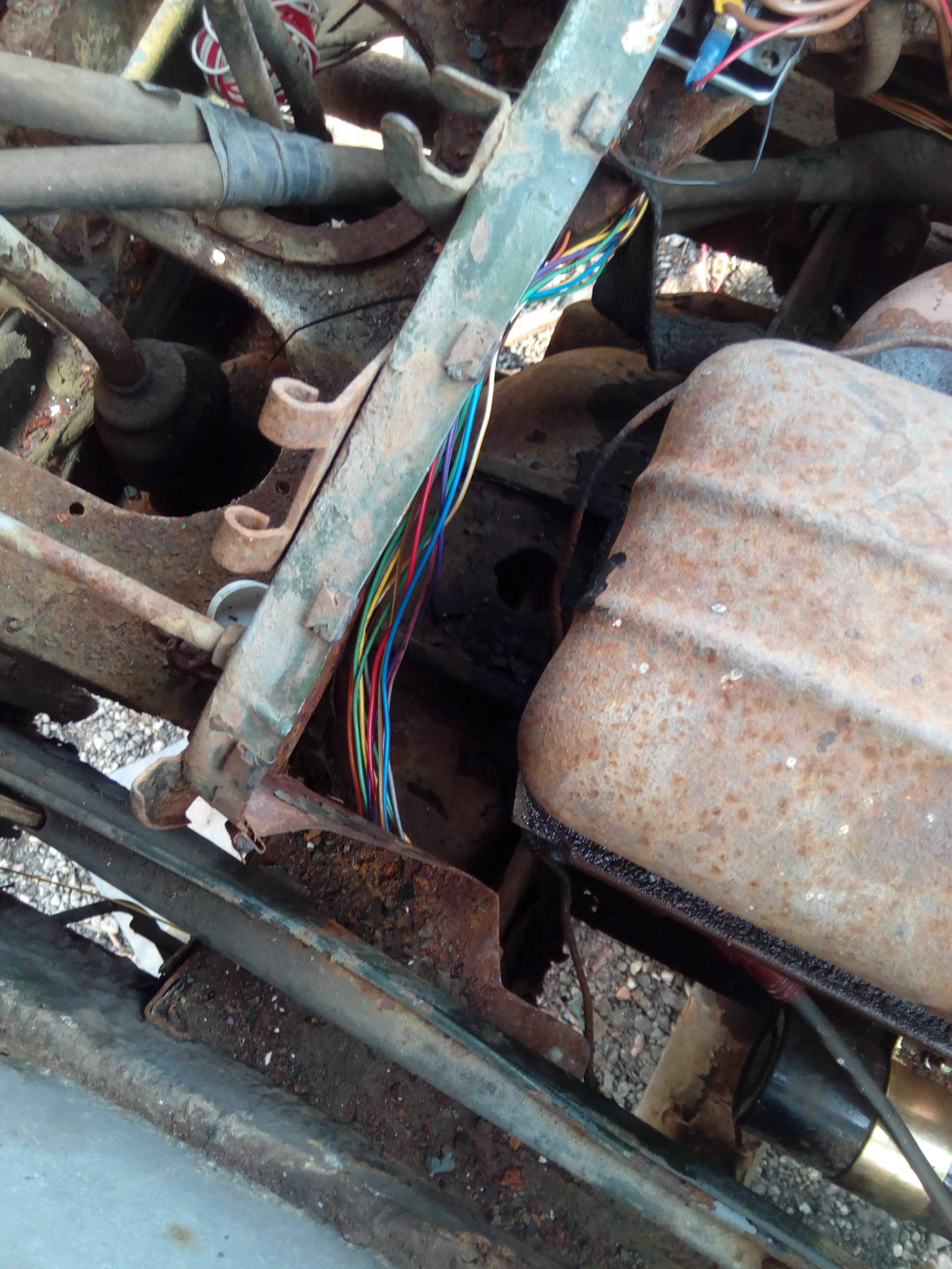 A rainbow of wires snaking its way through the engine bay, behind
the rusty engine