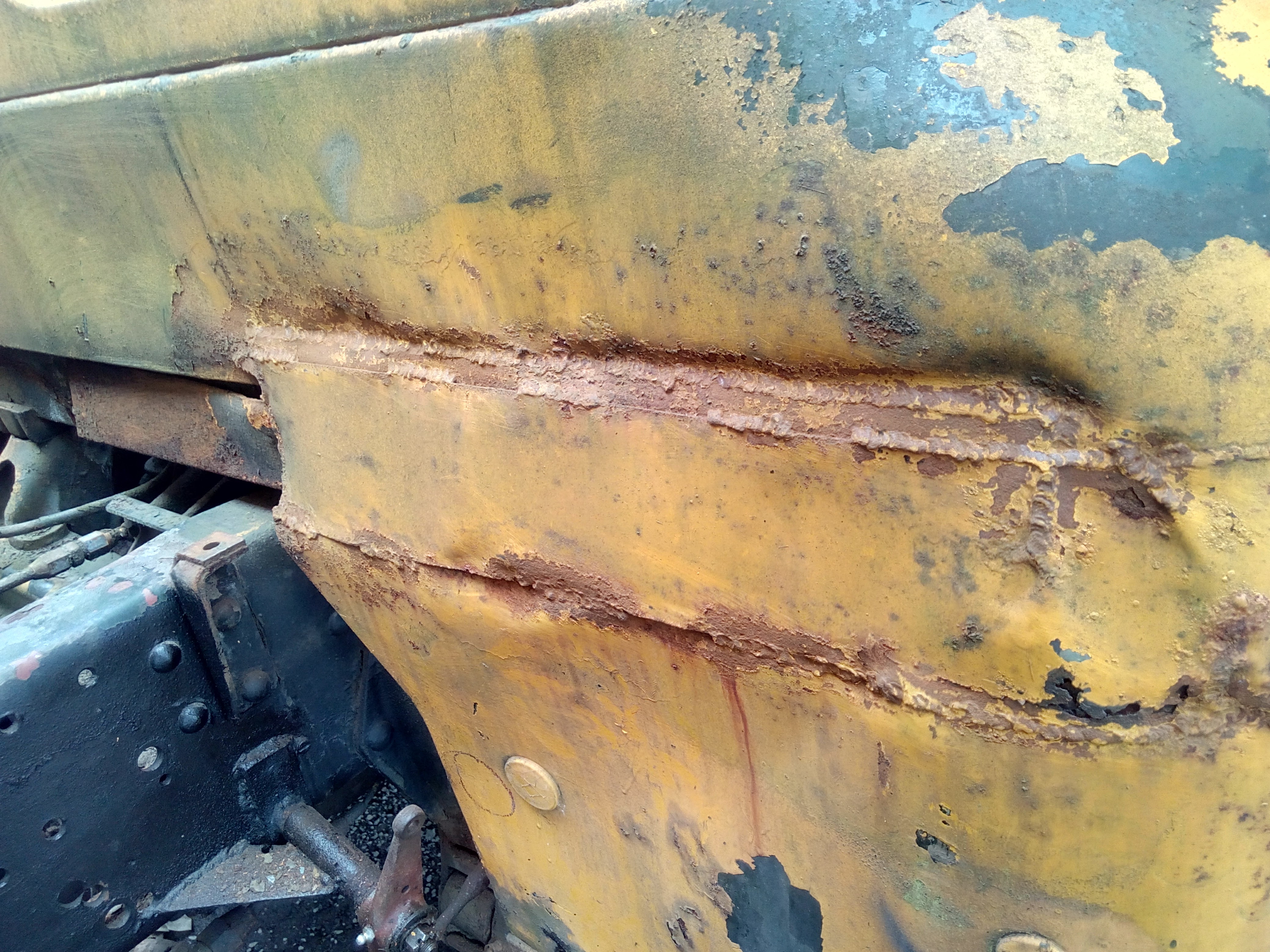 Photo of the back of the cab, showing a very large repair patch
that has been brazed in and signs of other crude repairs.