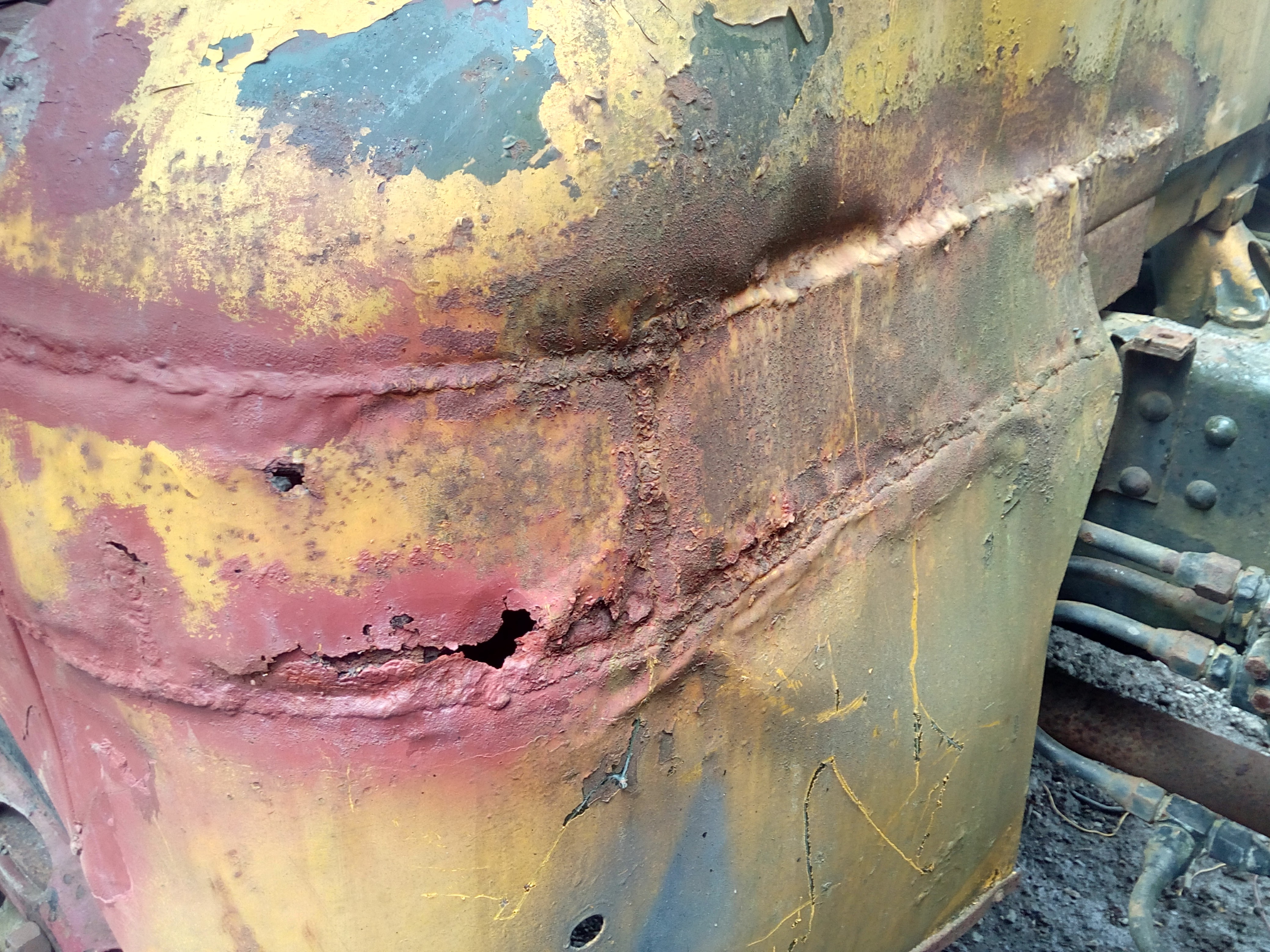 Photo of the other side of the cab back, showing another very
large repair patch that has been brazed in; the repair has since
corroded through and there are rust-holes.