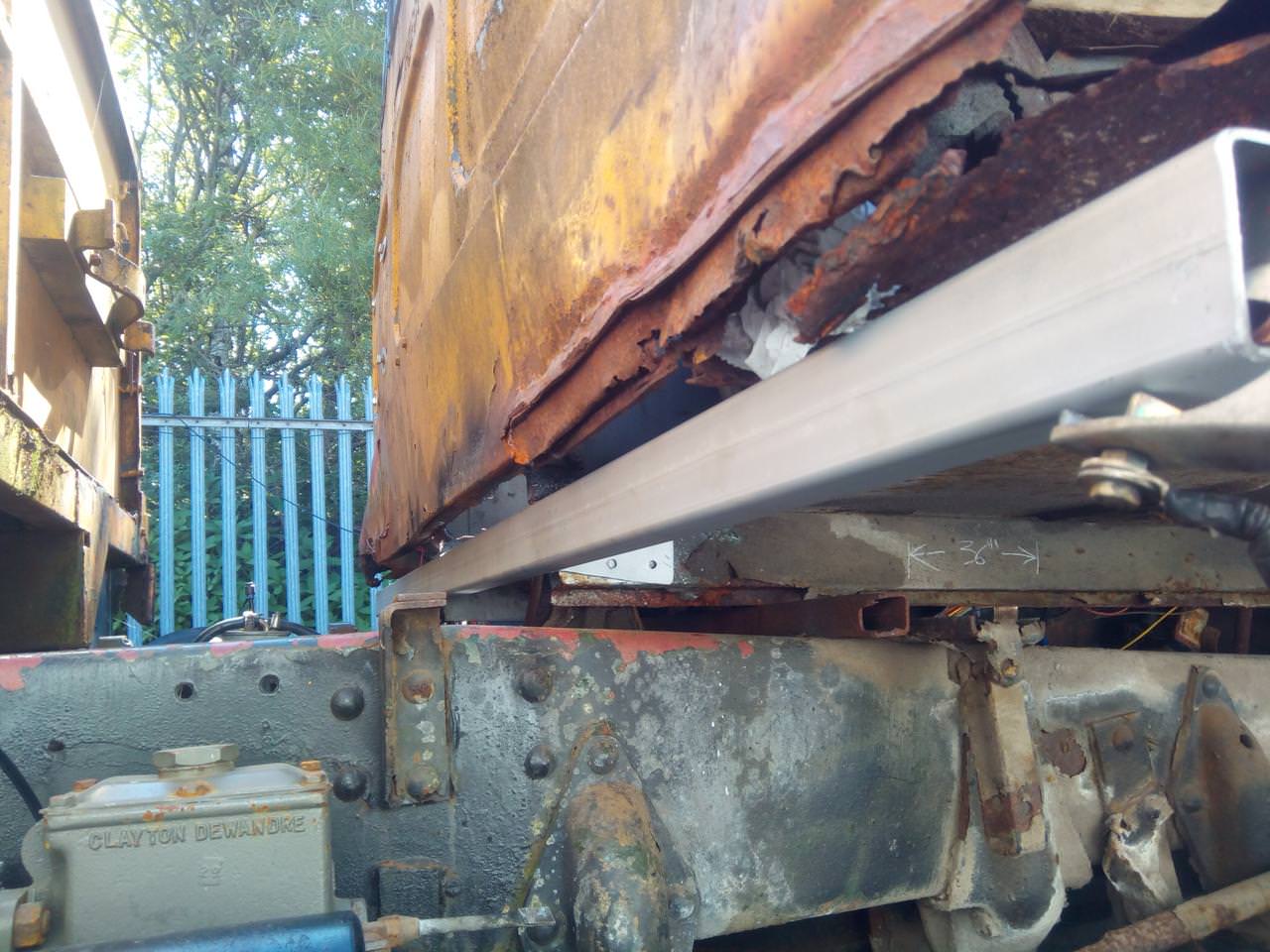 The square tubing pushed up into the back of the cab, with the
brackets either side of the cab frame rails. On the side of the frame
rail is chalked the measurement of 36 inches.