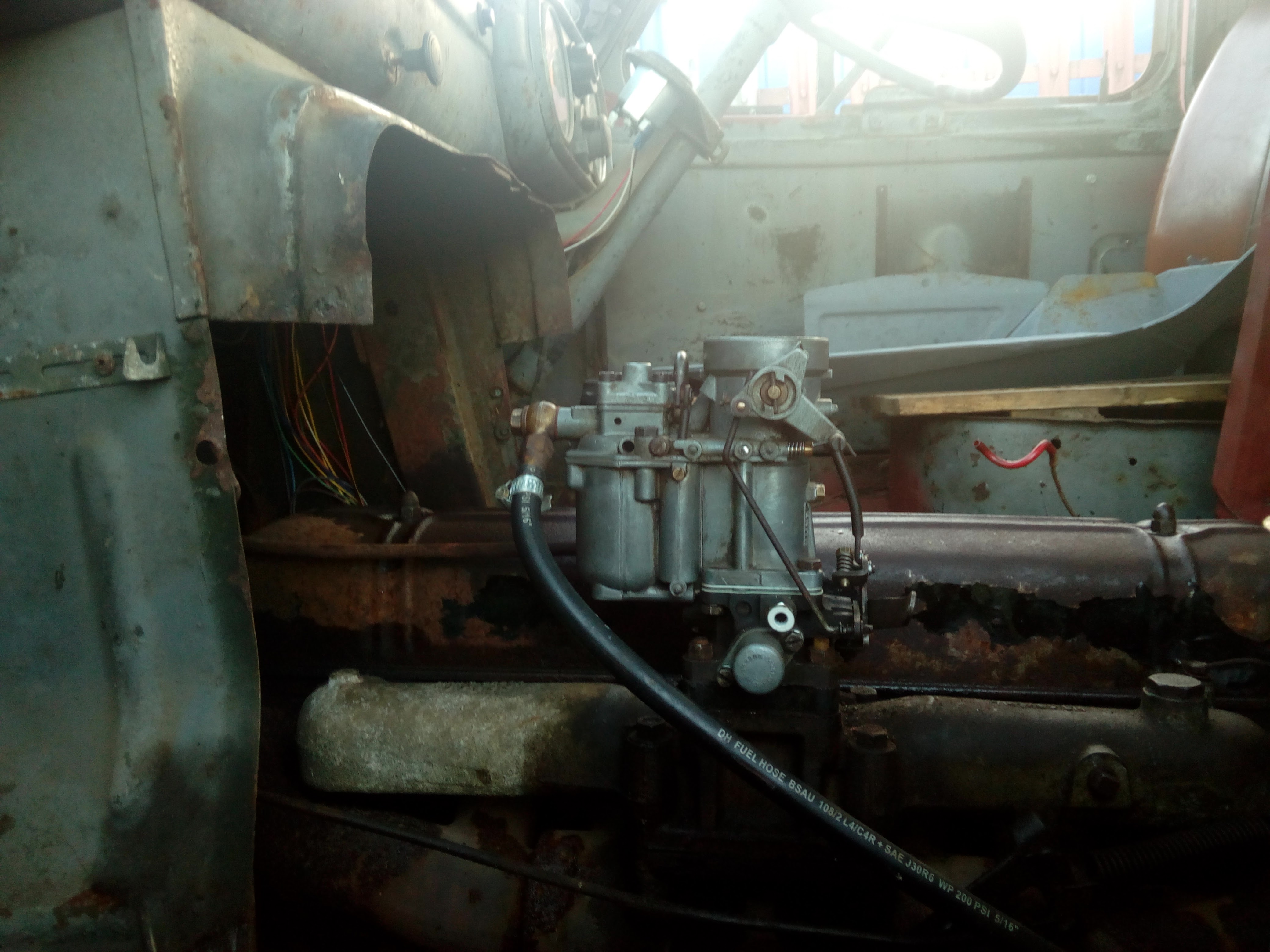 The carburettor refitted to the engine. The throttle linkage is
not connected, and under spring tension has gone to
wide-open-throttle.