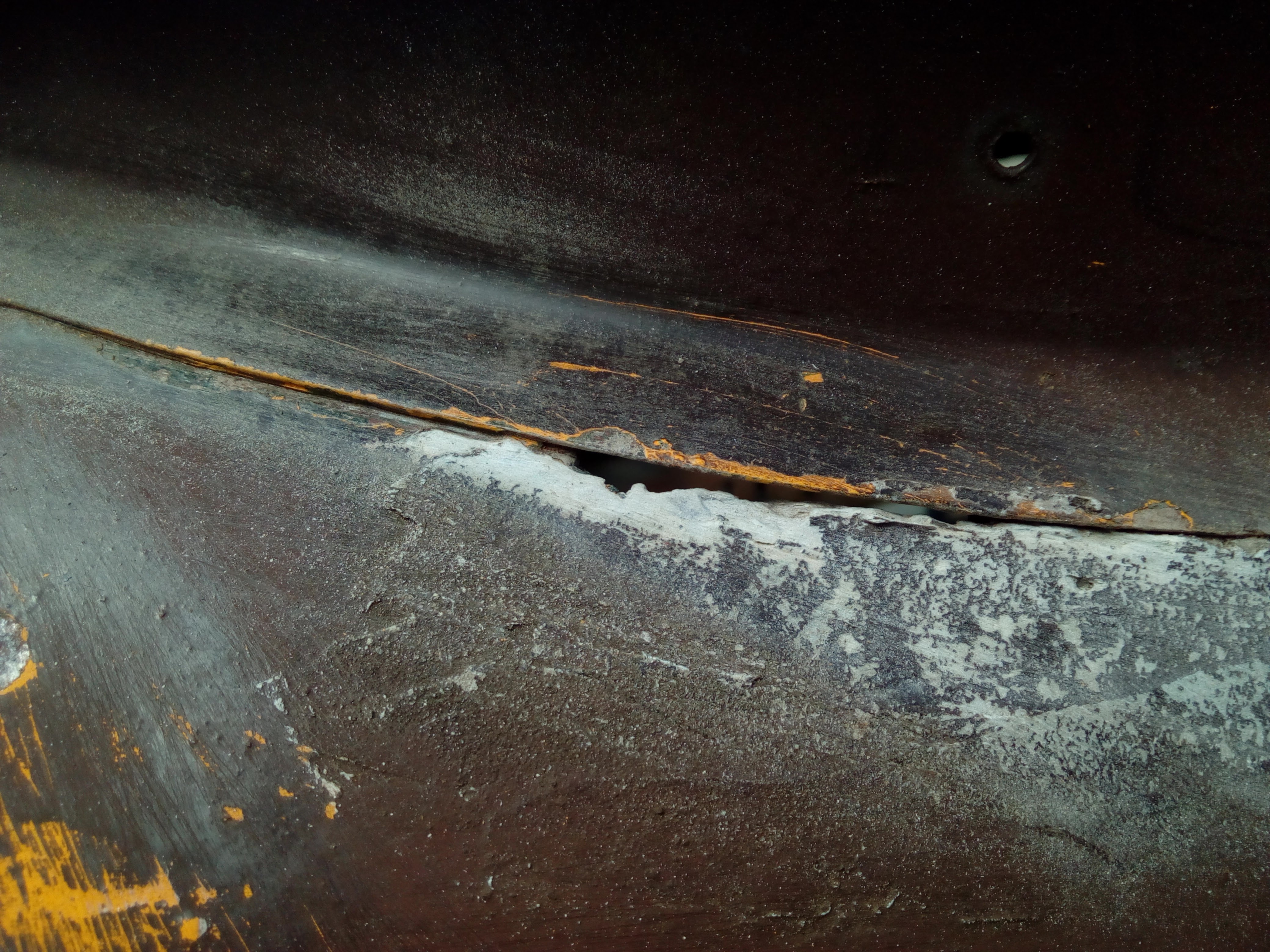 Close-ups of the body-filled rust holes around the edge of the roof 'turret'