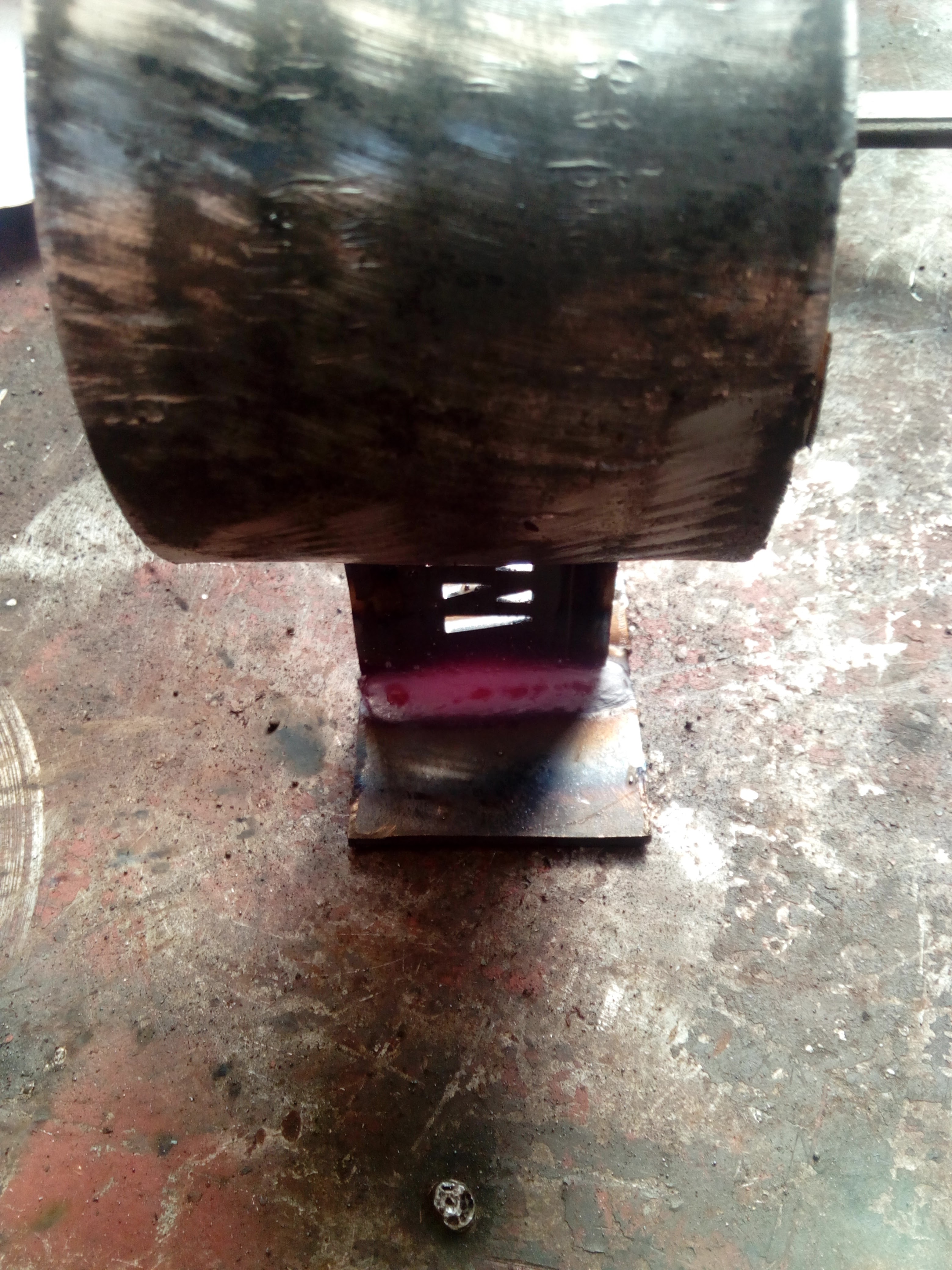 A freshly-welded bracket -- mostly a piece of tube welded to two
pieces of metal, one that has been profiled out by a
computer-controlled plasma cutter to have an M logo in it.
