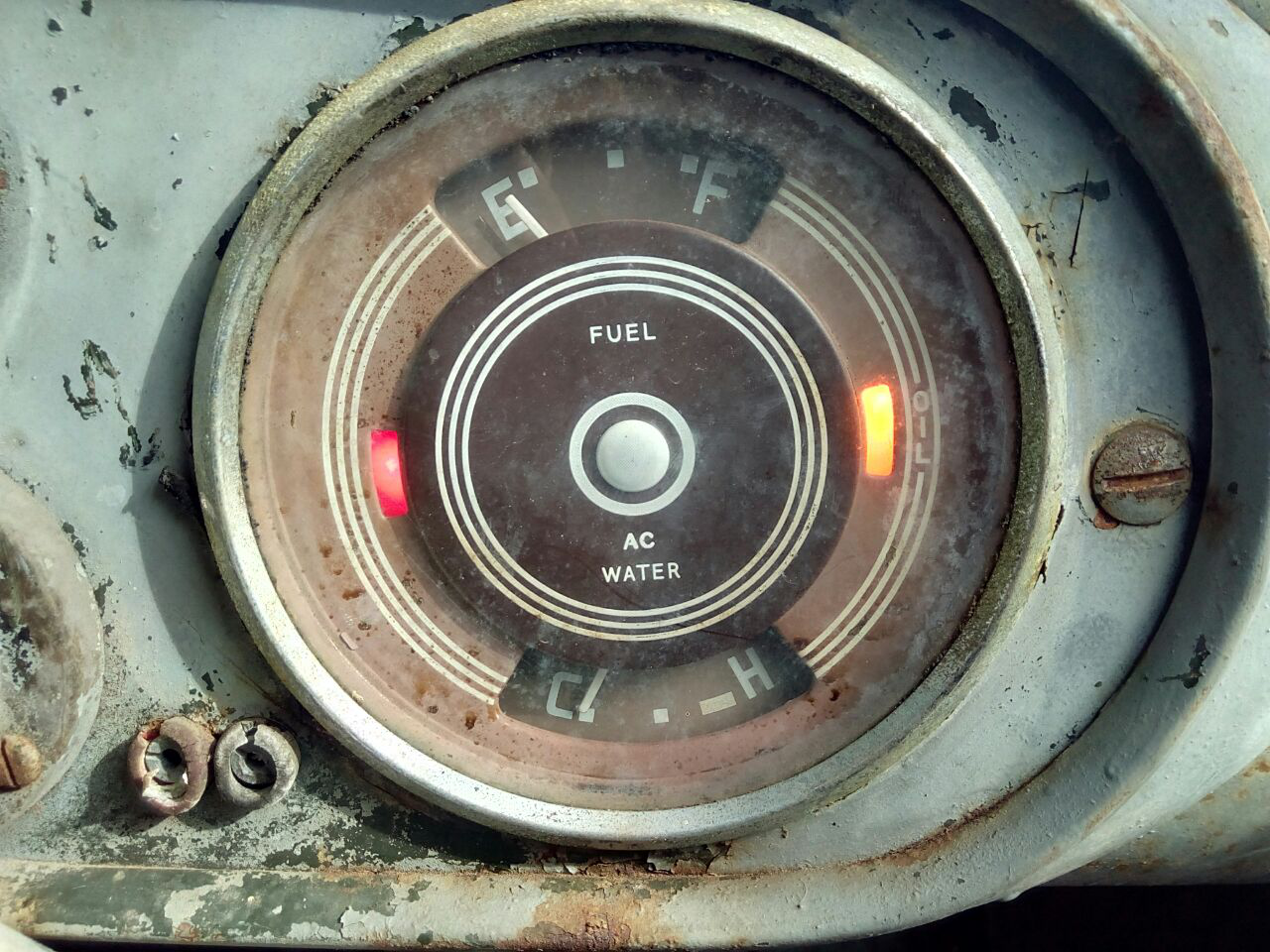 A photograph of the truck's instrument panel, close-up on the
combined fuel gauge/water temp gauge showing the oil pressure warning
and the charging warning lights illuminated.