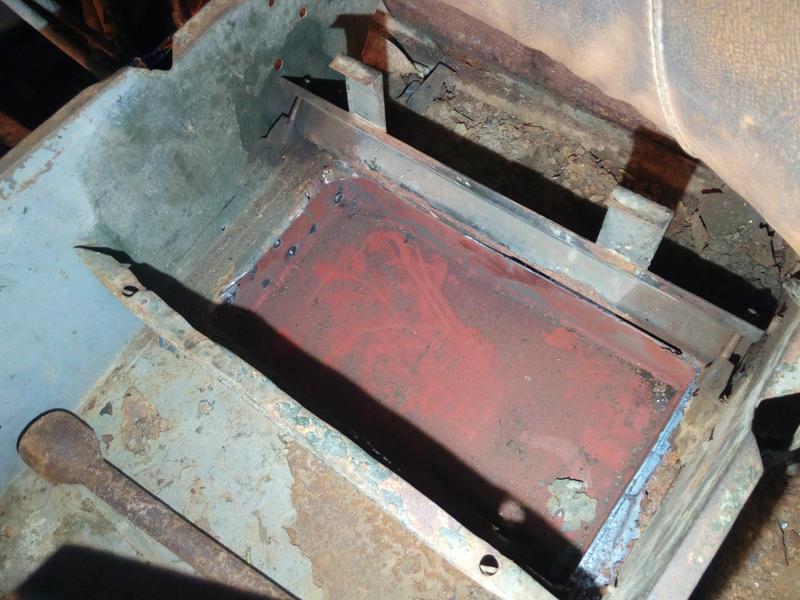 The previous red-painted welded steel tray, now welded into the
truck underneath the passenger's seat base.