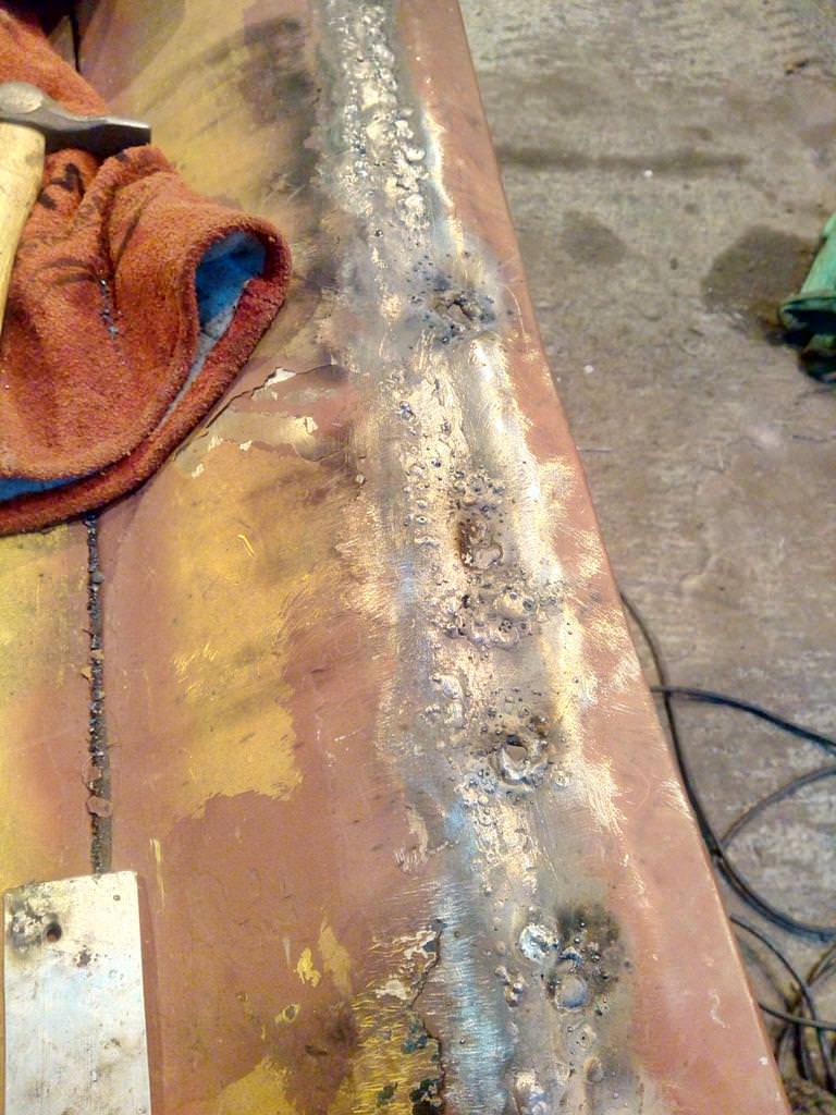 The bottom edge of the driver's door, with very crude welds
attaching the replacement metalwork