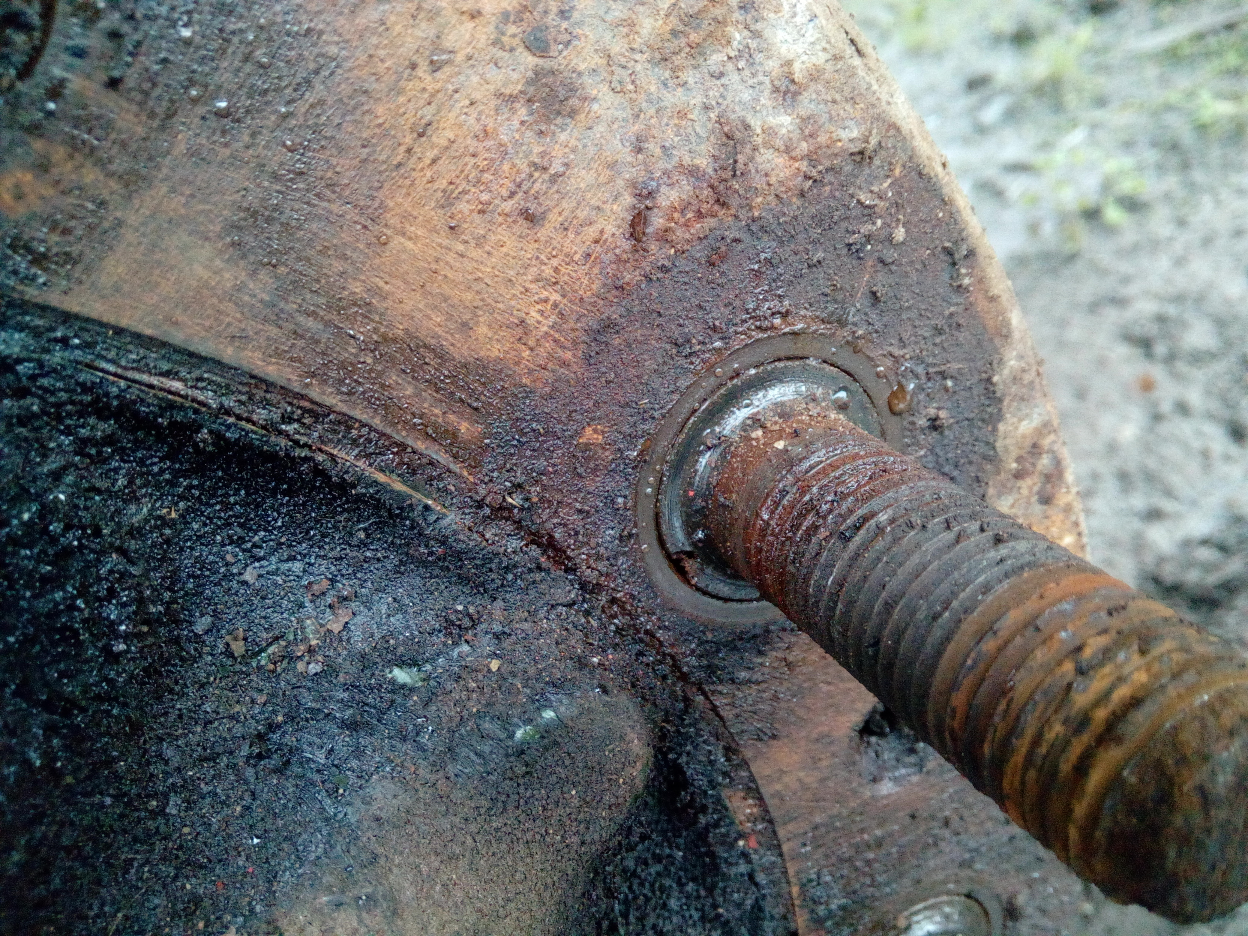 A close-up of a wheel-stud passing through a brake drum. The
tight fitting hole in the drum is somewhat rusty.