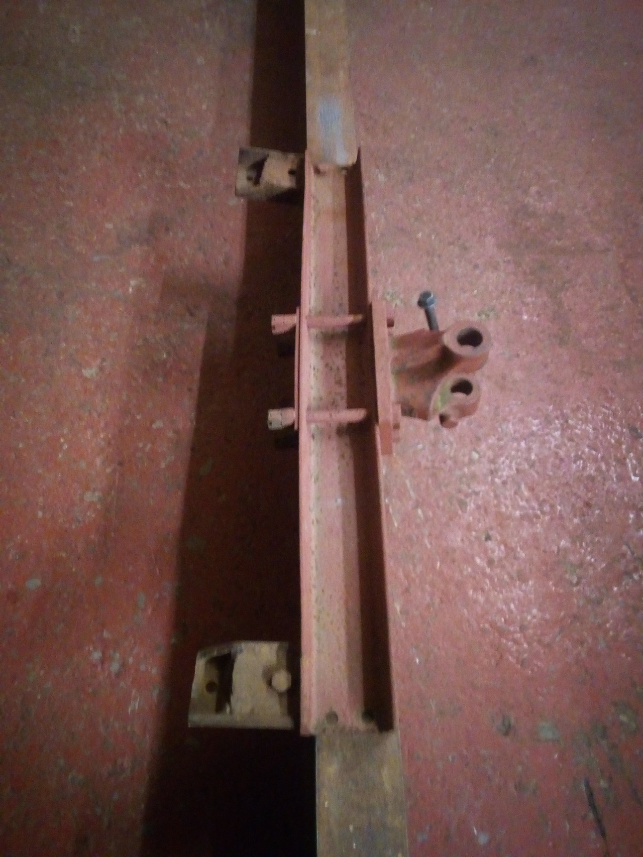 The front tow-beam from the truck, sitting on the workshop
floor. The beam is twisted and bent.