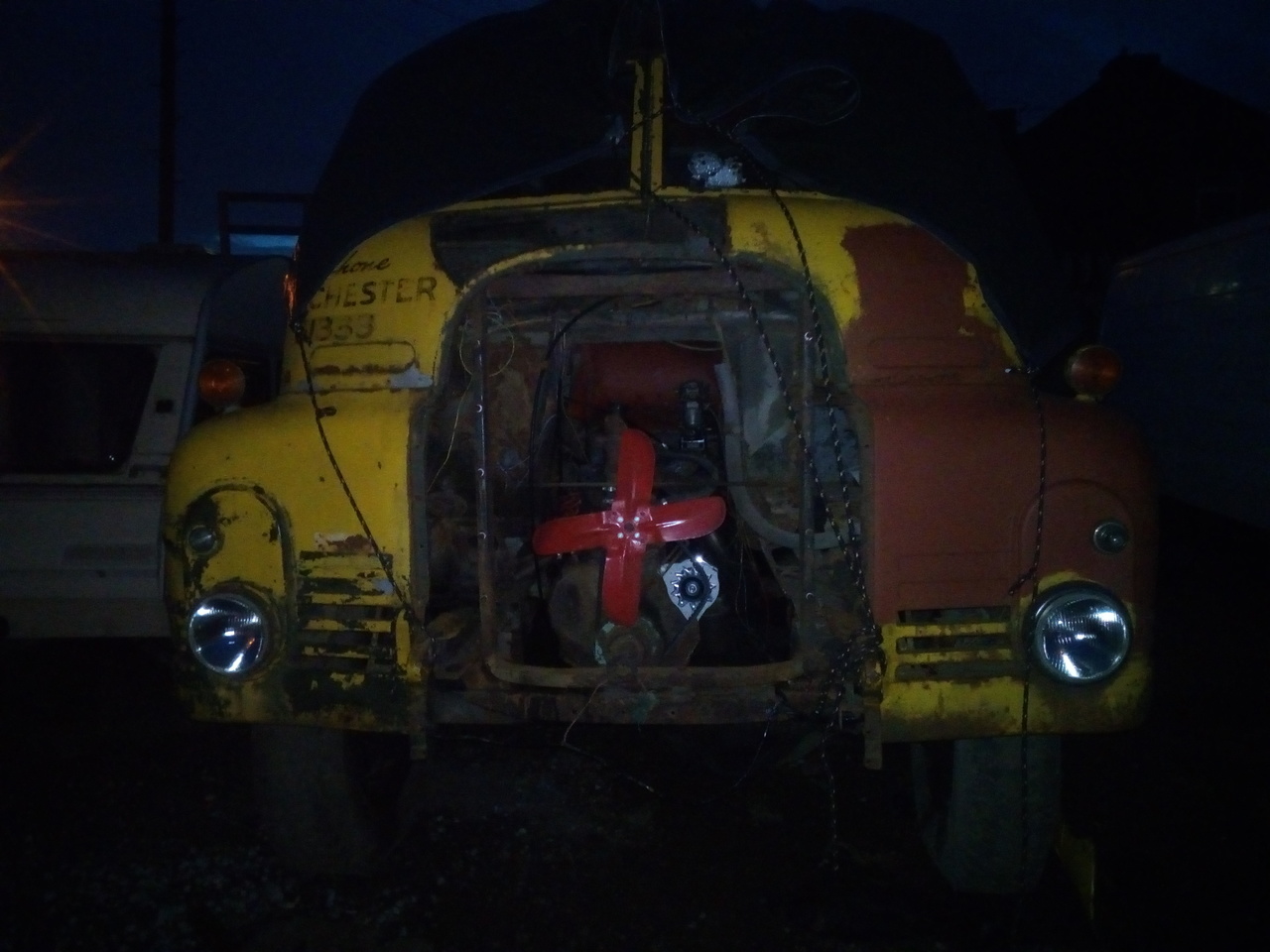 a night-time photograph of the truck, with the front bumper,
grille, and radiator removed. The fan and the engine are now
visible.