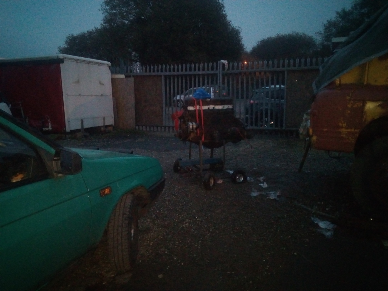 The engine, on its stand, now dragged a meter and a half away from the truck. Daylight is fading fast.