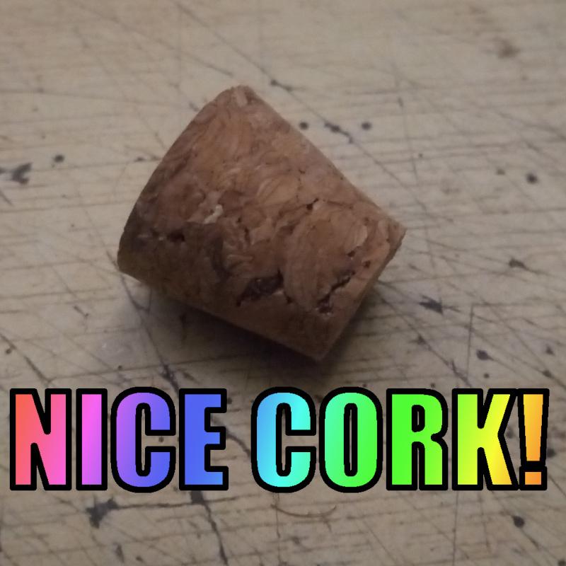 Small cork laying on a table. The words "Nice Cork" have been overlaid in rainbow text