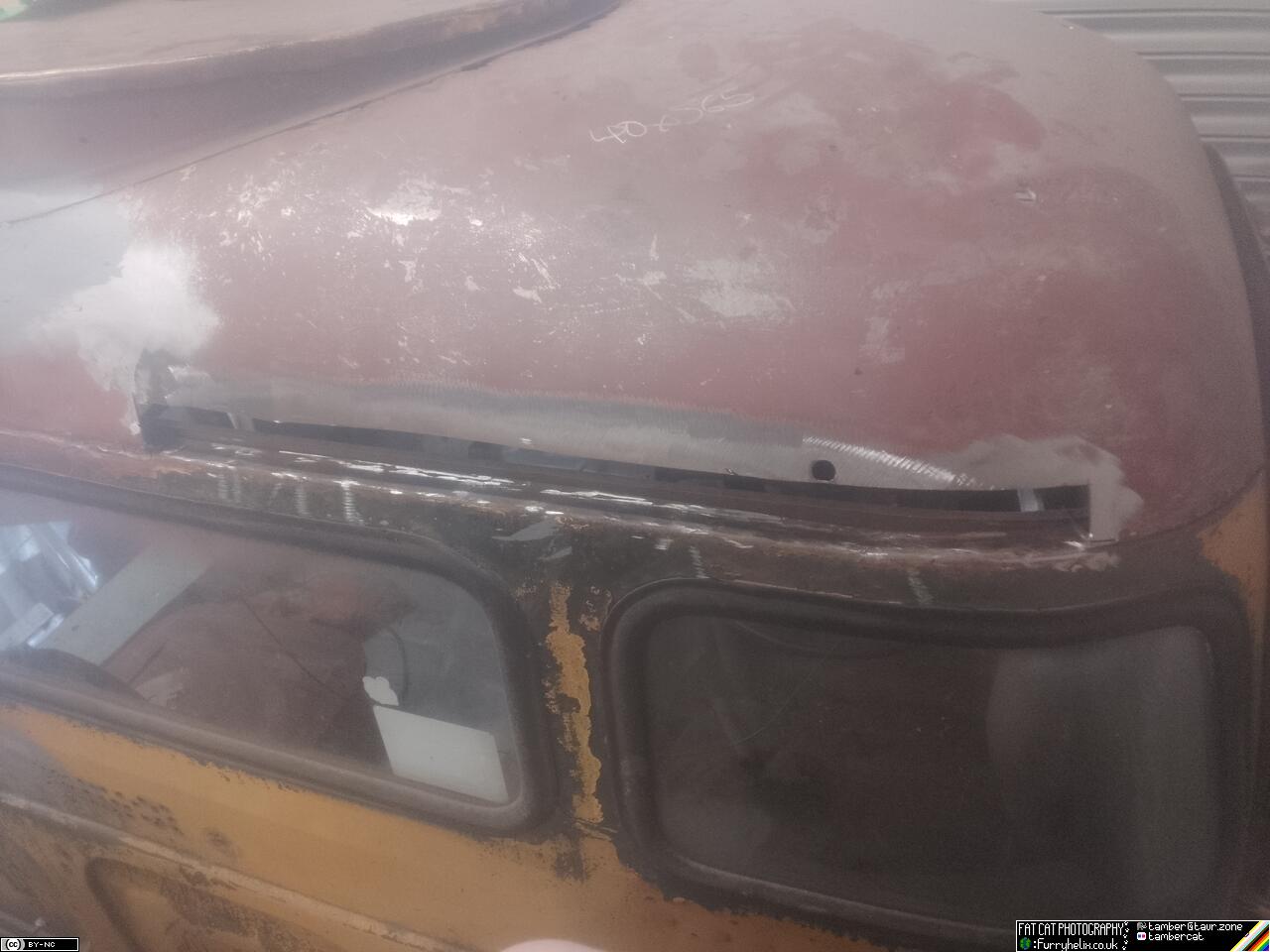 Back of the bedford's cab, with a wide strip cut out at the edge where the roof panel meets the rear wall of the cab