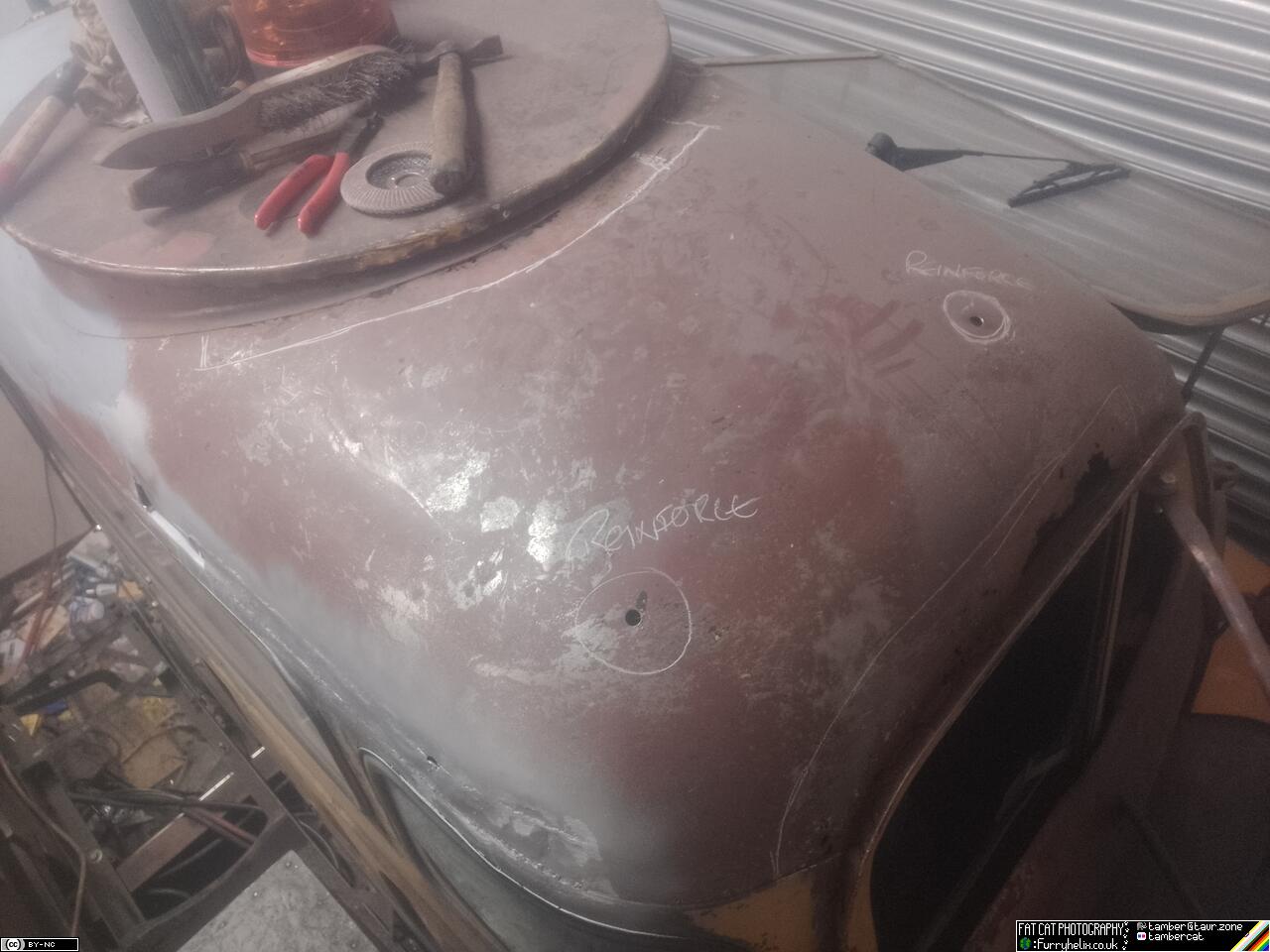 The cab roof pictured from above, with two bolt-holes circled in chalk and annotated with 'reinforce'