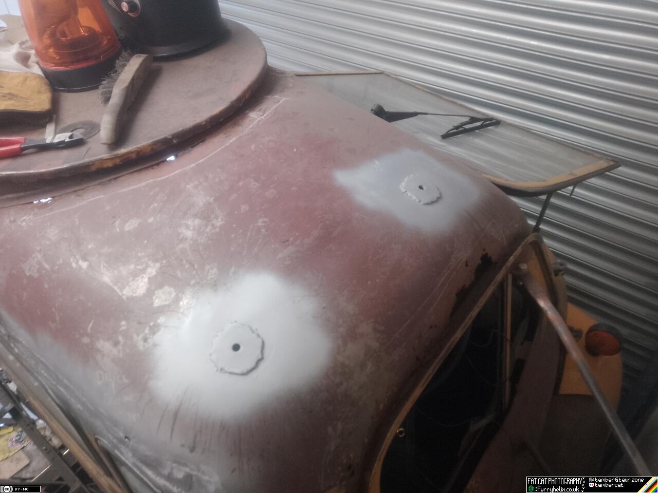 Both bolt-holes reinforced with large washers, and spray-painted in a silver primer
