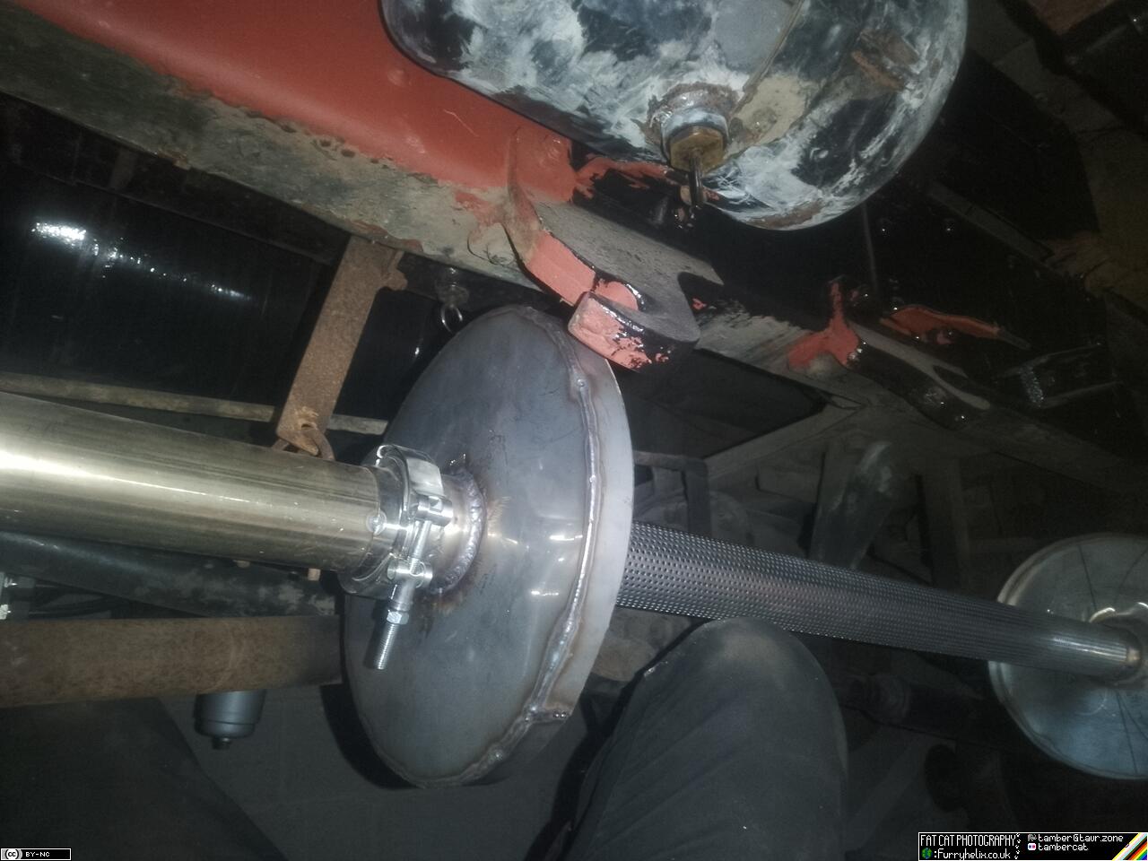 Trying to hold the skeleton of the silencer up in place under the truck. It's ridiculous and hits just about everything.