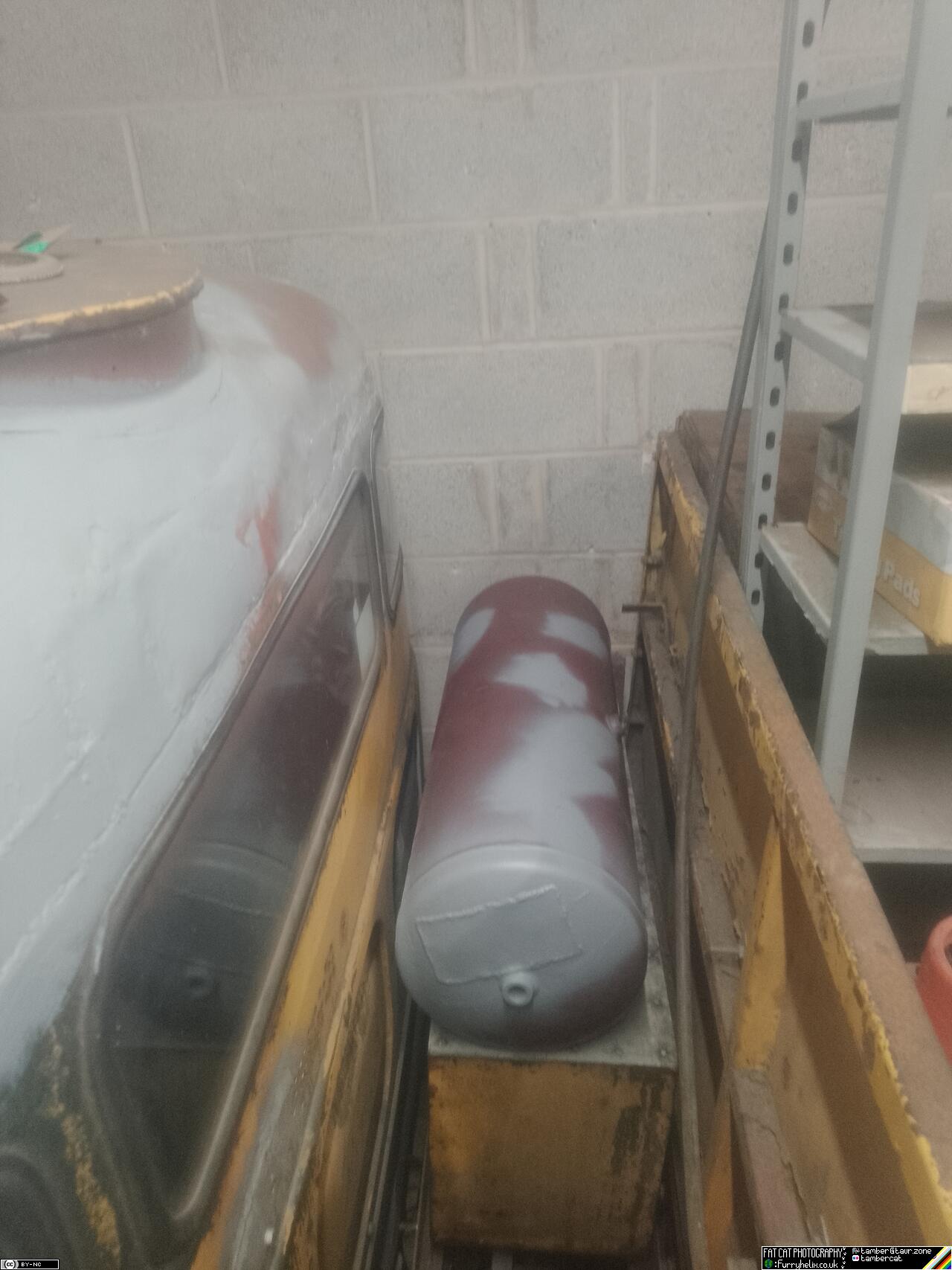 The repaired air-tank, sitting on top of the toolbox behind the driver's side of the cab