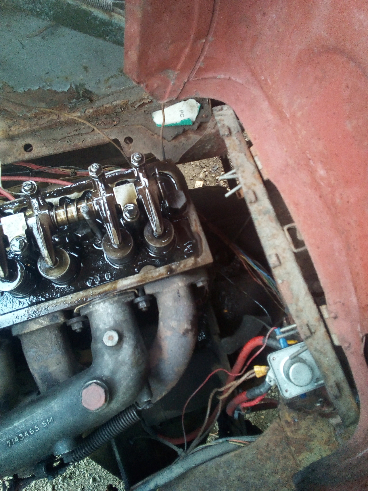 The engine with the rocker cover removed, and oil dribbling over
the back edge of the head.