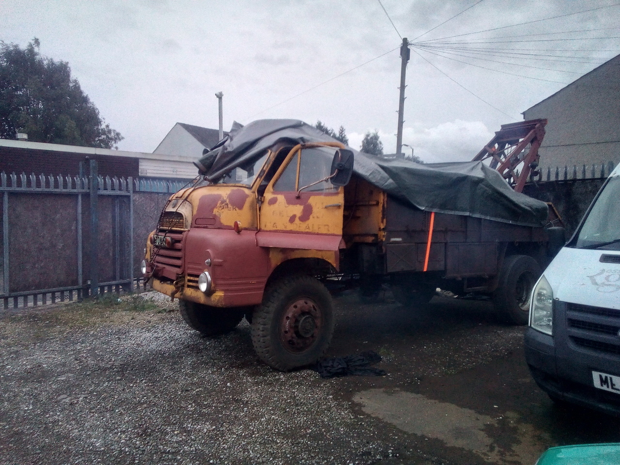 The truck, parked in a small gravel yard, with a cloud of smoke
blowing out from under it as the engine runs.