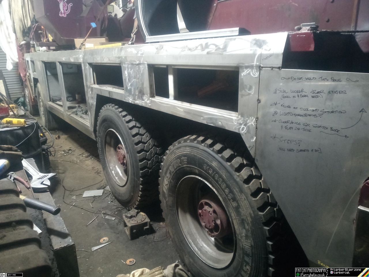 Very boxy stainless steel heavy recovery truck body, in a shed