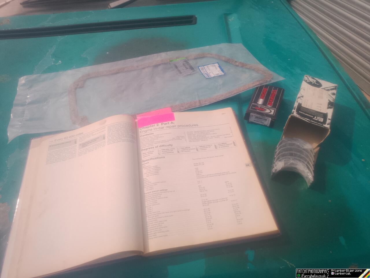 Main and rod bearings, a sump gasket, and a Haynes manual laid out on the bonnet of my car