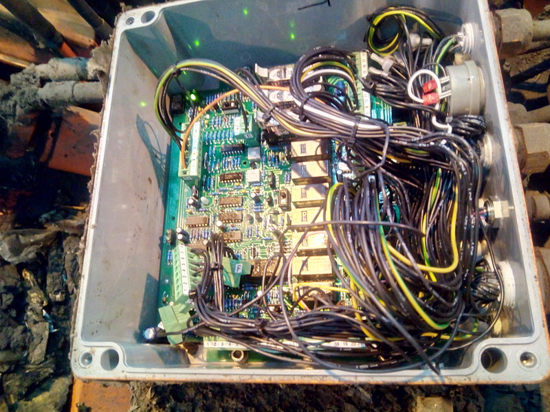 Control box opened, exposing a circuit board covered in relays, and a massive bundle of wire