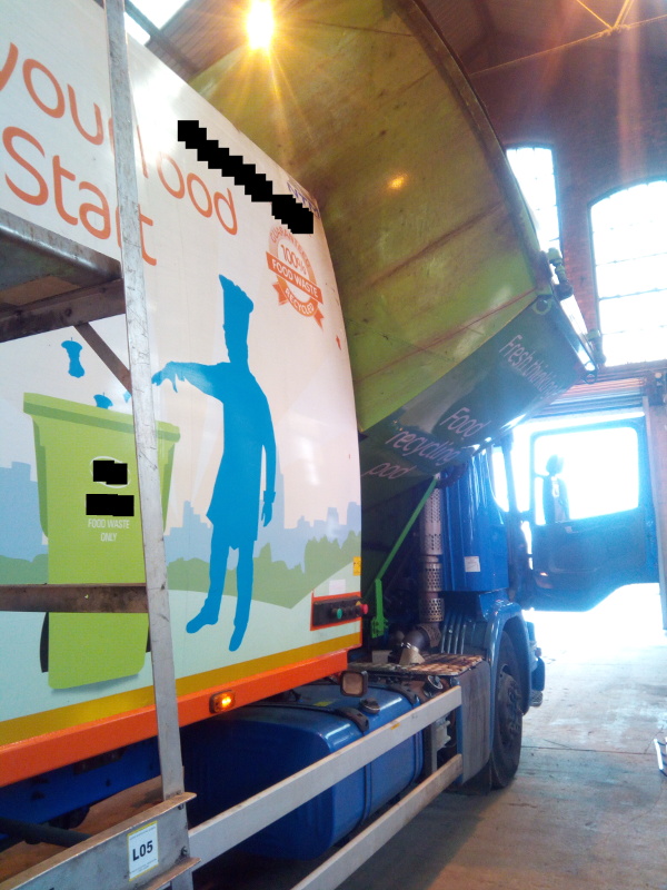 Truck-mounted recycling pod tipping sideways