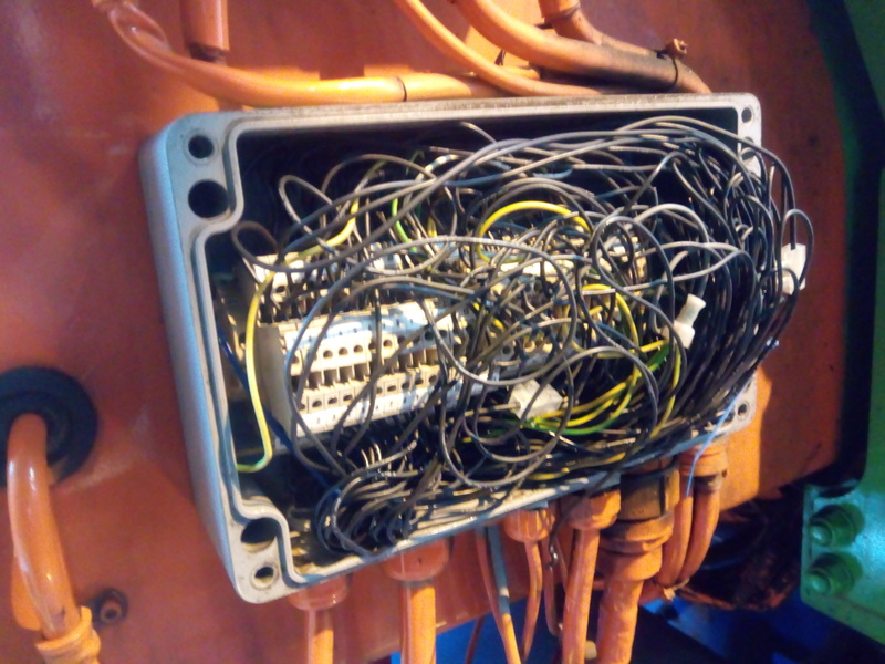 Junction box opened, stuffed with masses of all-black wire